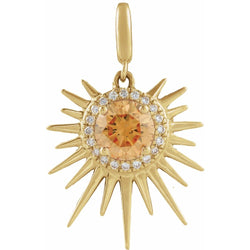 Gold sun-shaped pendant with a central orange gemstone and smaller diamonds on a white background