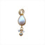 A pear shaped pear bezel set in gold over silver. with interesting two round bails and three diamond charms dangling at the bottom.