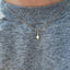 A four point star charm hanging on a beaded chain