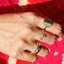 Showing a half circle half diamond ring stacked with other similar styled rings. 