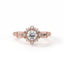 Rose gold ring with a diamond on a white background