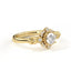 Gold ring with a diamond on a white background