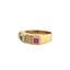 A vintage ring with three colored gemstones princess cut. Emerald in the middle and ruby and blue sapphire on either side with diamonds in between. 