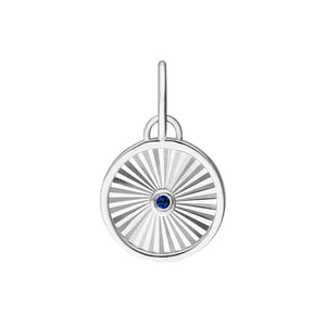 A round pendant with a ray design going toward a center sapphire. The sapphire is bezel set along with a plain white gold boarder.