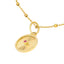 A round pendant with a ray design going toward a center ruby. The ruby is bezel set along with a plain gold boarder.