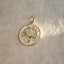 A round coin pendant with reversable two sides. One side is navy enameled "OM" sign, and on the other it is a lotus with a "OM" sign carved in the flower.