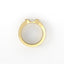 Gold ring with a white stone on a white background