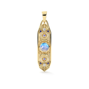 A gold pendant with a moonstone center and crescent on both sides to mimic the phases of the moon. Made with stars and blue palette colored gemstones. 
