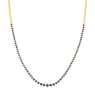 Gold necklace with blue beads on a white background