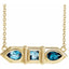 Gold necklace with blue gemstones on a white background