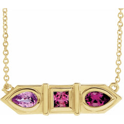 Gold necklace with pink gemstones on a white background