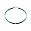 A faceted gemstone ombre beaded bracelet with three gold accents and a round clasp. 