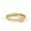 Gold ring with intricate design on a white background