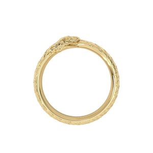 Gold ring with intricate design on a white background