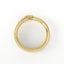 Gold ring with intricate design on a white background