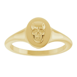 An oval signet ring with a three dimensional skull set on its surface. This ring has a vintage vibe. 