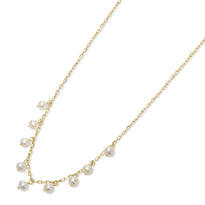 Gold necklace with pearls on a white background