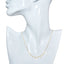 Gold necklace on a mannequin bust against a white background