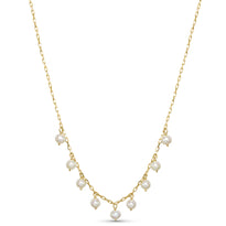 Gold necklace with pearls on a white background
