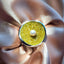 A large cocktail ring with a big around face set with yellow crystals and a freshwater pearl set on top. 