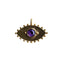 A gold eye pendant with a round colored gemstone bezel set on the center. With gold beaded detailed designs are the outer boarder. 