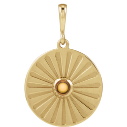 A round coin pendant with a round natural colored gemstone and a starburst ray design. 