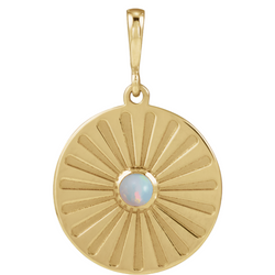 A round coin pendant with a round natural colored gemstone and a starburst ray design. 