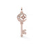 Rose gold key-shaped pendant with star and moon design on a white background