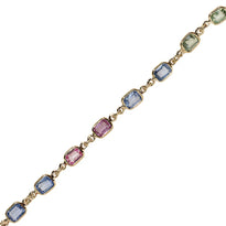 A rainbow sapphire chain bezel set in gold.