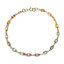 A rainbow sapphire chain bezel set in gold.