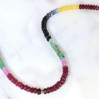 A necklace with multi-colored section of sapphires finished with solid yellow gold clasp.