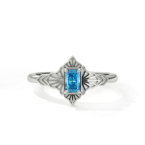 Silver ring with a blue gemstone on a white background