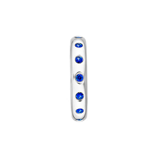 A blue sapphire eternity ring made in white gold with round blue sapphires. 