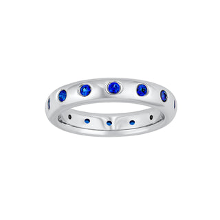 A blue sapphire eternity ring made in white gold with round blue sapphires. 