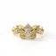 Gold bracelet with diamond accents on a white background