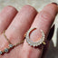 Gold ring with diamond accents on a finger