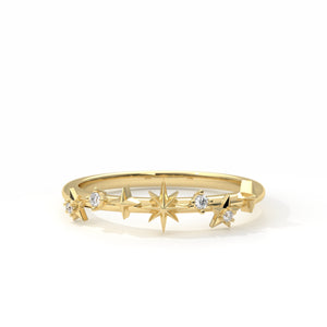 Gold ring with star designs on a white background