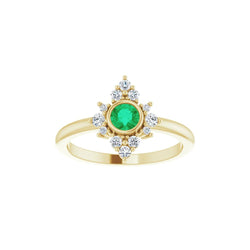 Gold ring with a green gemstone and diamond accents on a white background