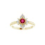 Gold ring with a red gemstone and diamond accents on a white background