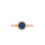 A rose gold solitaire ring with a bezel set round blue sapphire and a simple band.