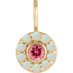 A round pendant with a pink spinel or a red garnet center stone and a turquoise or a opal halo. 