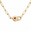 A gold paperclip chain necklace featuring a central heart-shaped padlock pendant with a red heart, a small clear gemstone, and a sunburst pattern, shown on a white background.