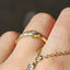 Gold ring with intricate design on a textured surface with a blurred background