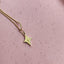 A four point star charm hanging on a beaded chain