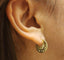 A pair of round gold hoops with star design and diamonds. Snap closure and scalloped edges . 