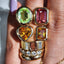 A toi et moi ring or two stone ring with one heart shaped citrine and the other emerald cut citrine. Both bezel set on a thick heavy band. 