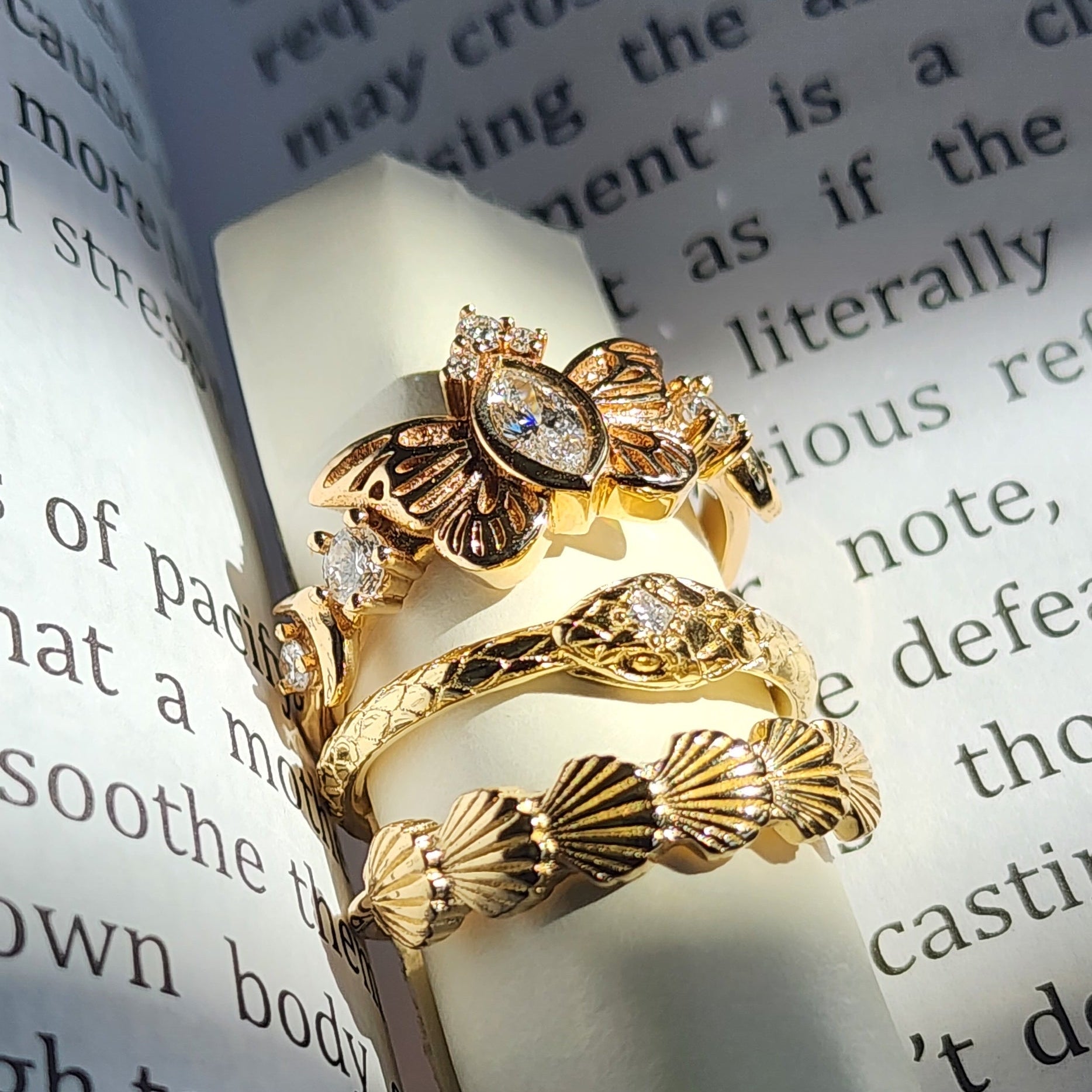 Two gold rings on a piece of paper with text