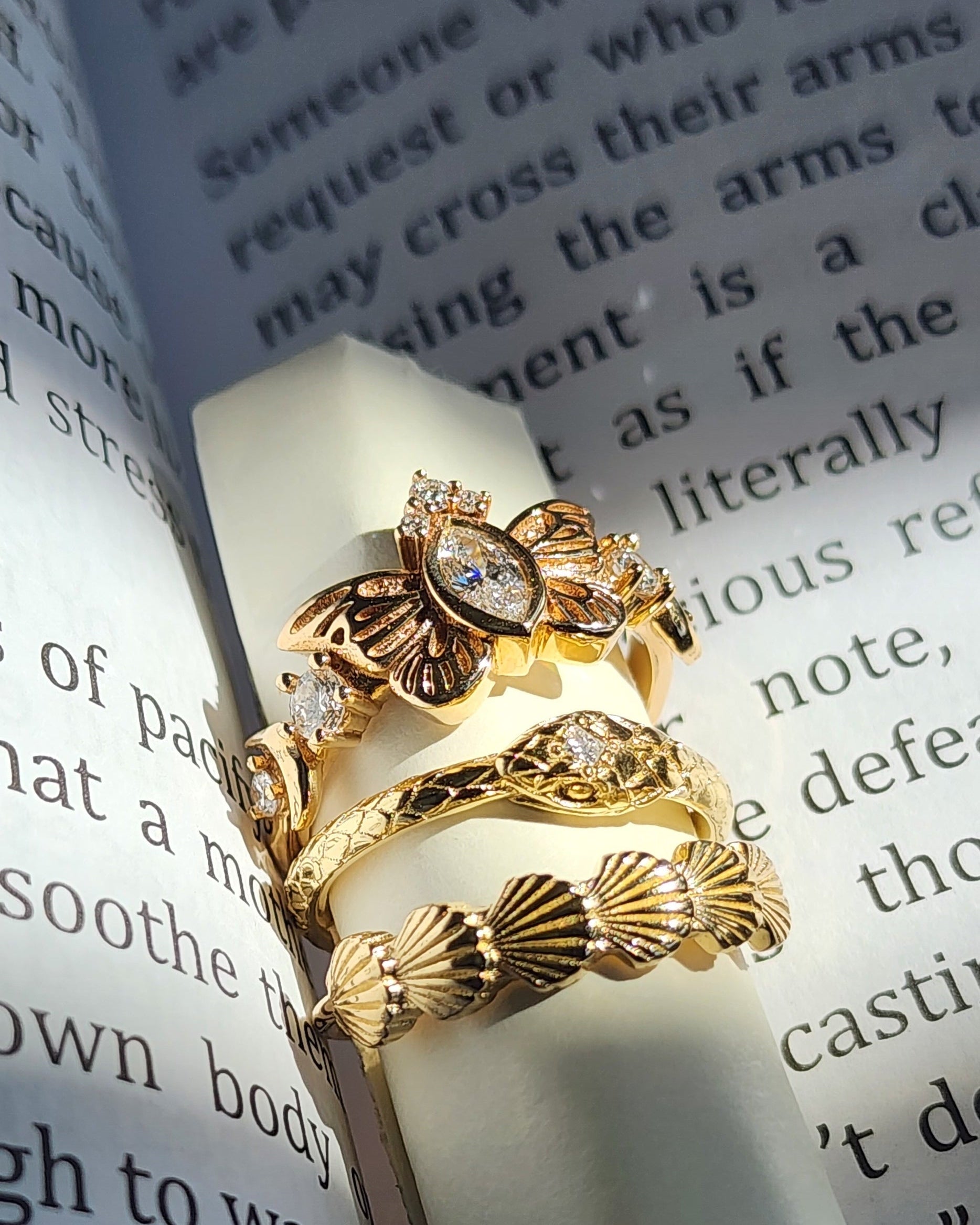 Two gold rings on a piece of paper with text