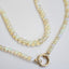A bubble opal beaded necklace with two round loops at the ends. Available in black and white rounded smooth beads. 