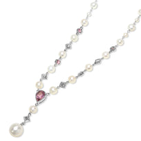 Pearl necklace with pink heart-shaped gem and silver accents on a white background